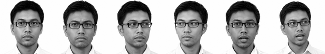 A man with short dark hair and glasses